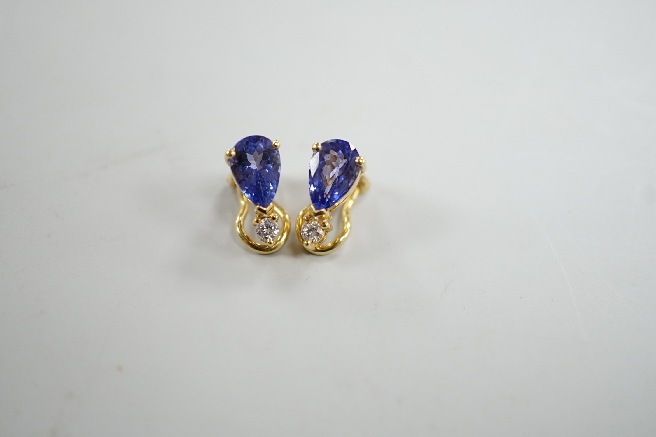 A modern pair of 18k, tanzanite and diamond set ear clips, 13mm, gross weight 4.4 grams.